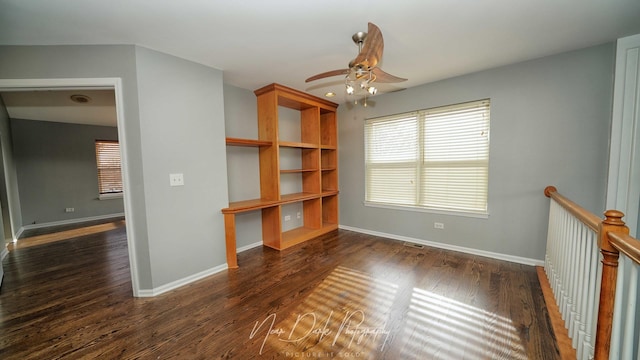 interior space featuring dark wood-type flooring and ceiling fan