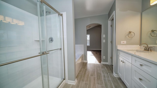 bathroom with vanity and separate shower and tub