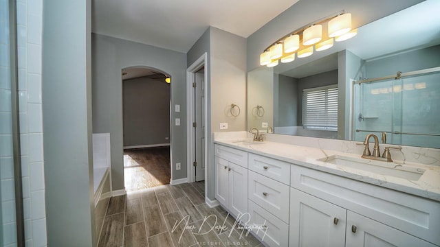 bathroom featuring vanity and plus walk in shower