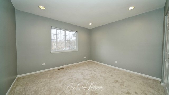 unfurnished room with light carpet