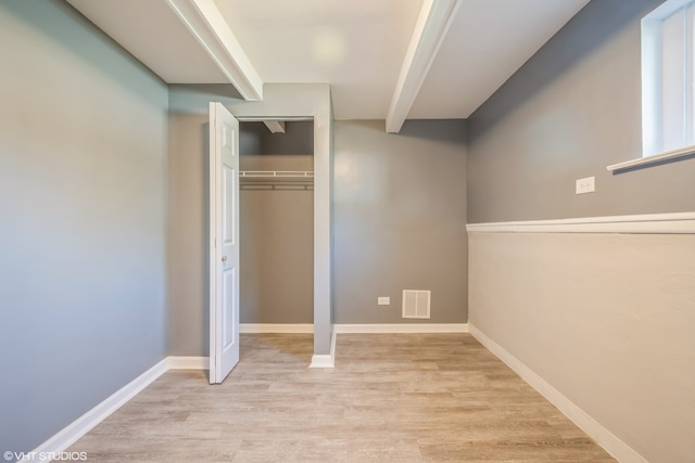 unfurnished bedroom with light hardwood / wood-style floors and a closet