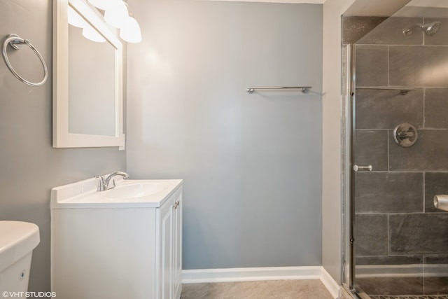 bathroom featuring vanity, a shower with shower door, toilet, and tile patterned flooring