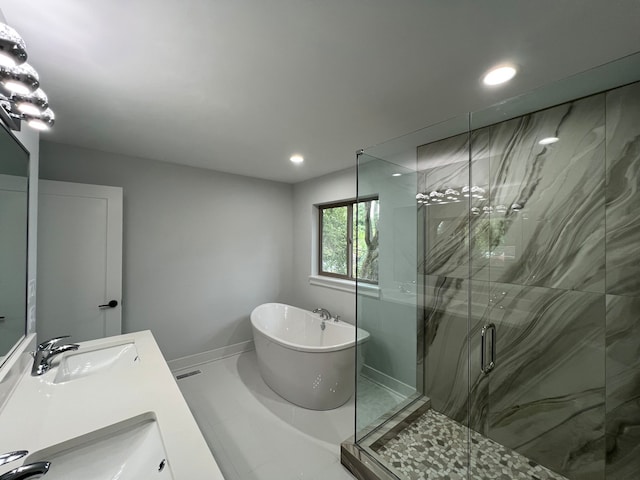 bathroom with vanity and separate shower and tub