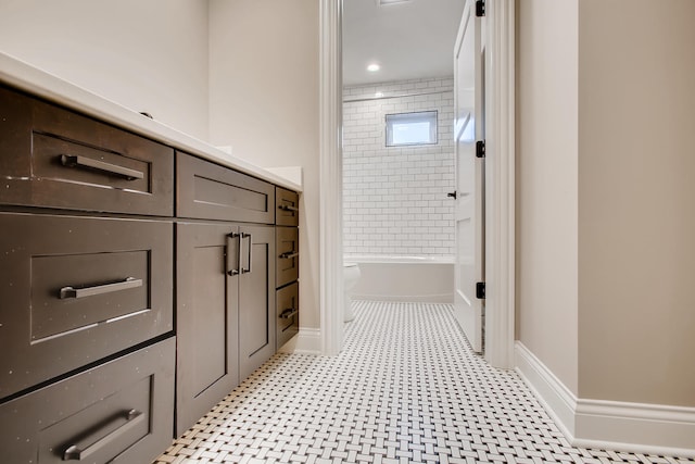 full bathroom with tile floors, toilet, vanity, and tiled shower / bath