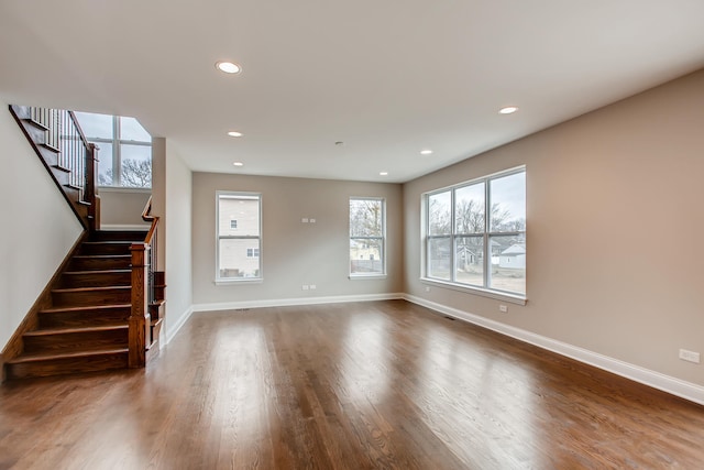 unfurnished living room with dark hardwood / wood-style flooring