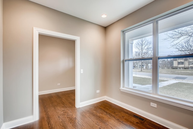 spare room with dark hardwood / wood-style floors