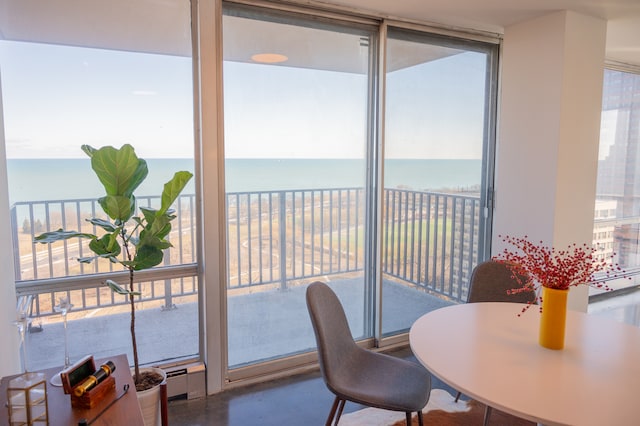 sunroom / solarium featuring a water view