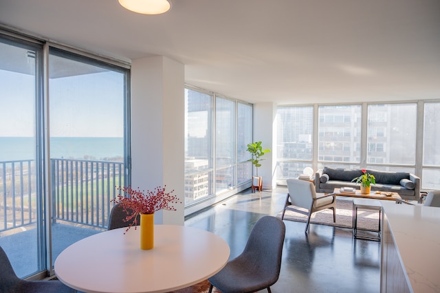 dining area featuring a water view and floor to ceiling windows