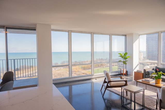 sunroom / solarium featuring a water view