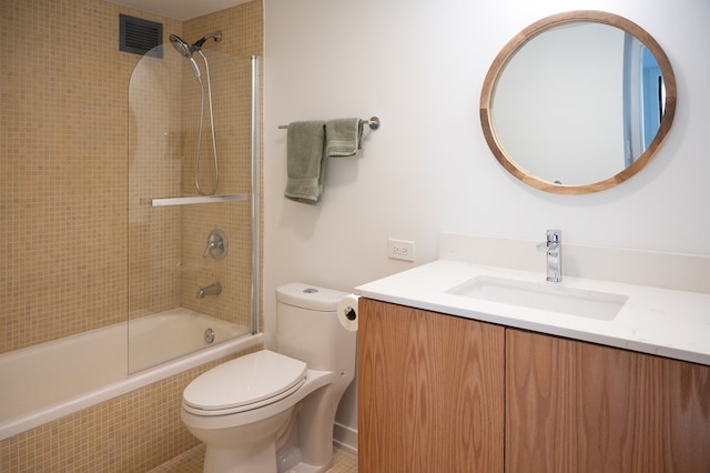 full bathroom featuring toilet, combined bath / shower with glass door, and vanity