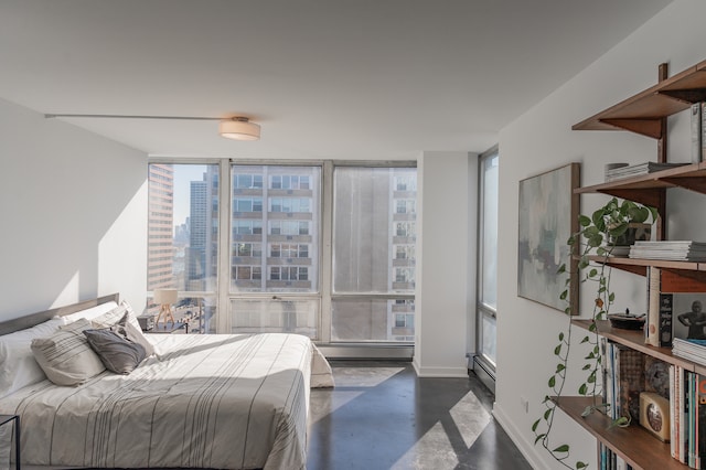 bedroom with a baseboard radiator and expansive windows