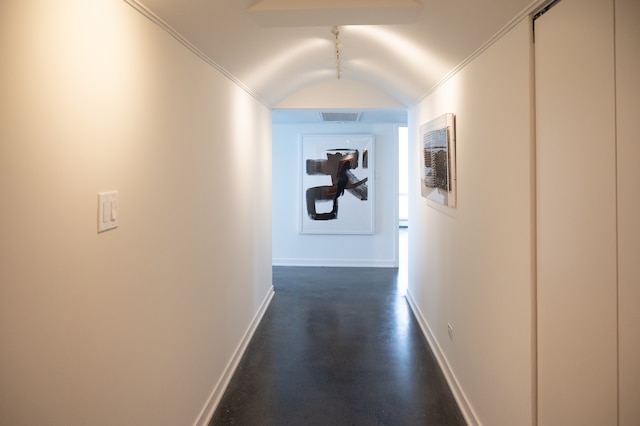 corridor featuring lofted ceiling, dark hardwood / wood-style floors, ornamental molding, and rail lighting