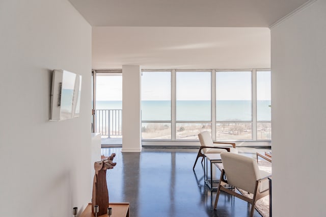 living room with a water view and floor to ceiling windows