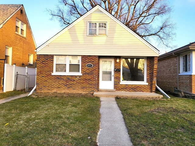 bungalow-style house with a front lawn