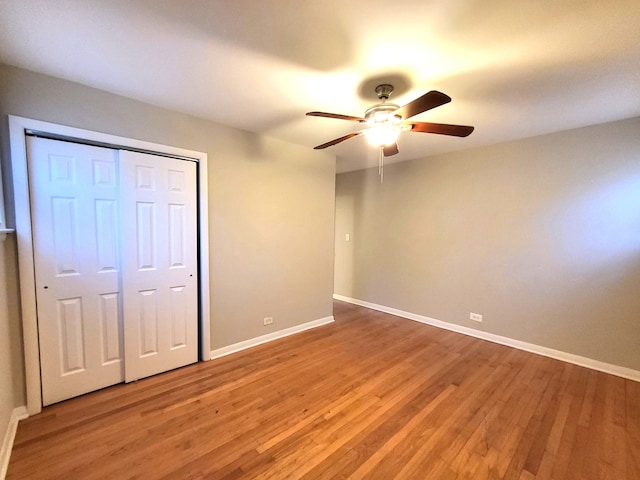 unfurnished bedroom featuring ceiling fan, light hardwood / wood-style flooring, and a closet