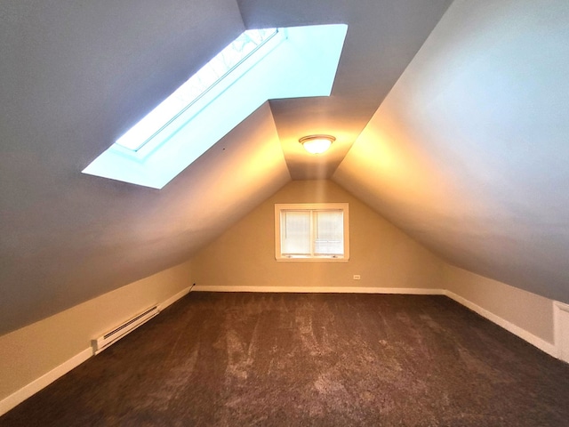 bonus room featuring lofted ceiling with skylight, baseboard heating, and dark colored carpet