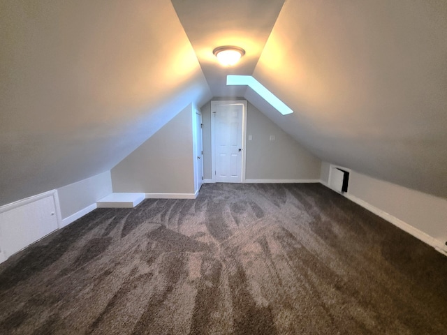 bonus room featuring dark carpet and vaulted ceiling