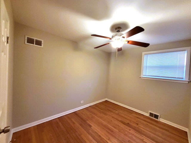 spare room featuring ceiling fan and dark wood-type flooring