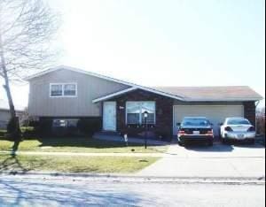 6151 Victoria Dr, Oak Forest, IL 60452 - split level home featuring concrete driveway and an attached garage