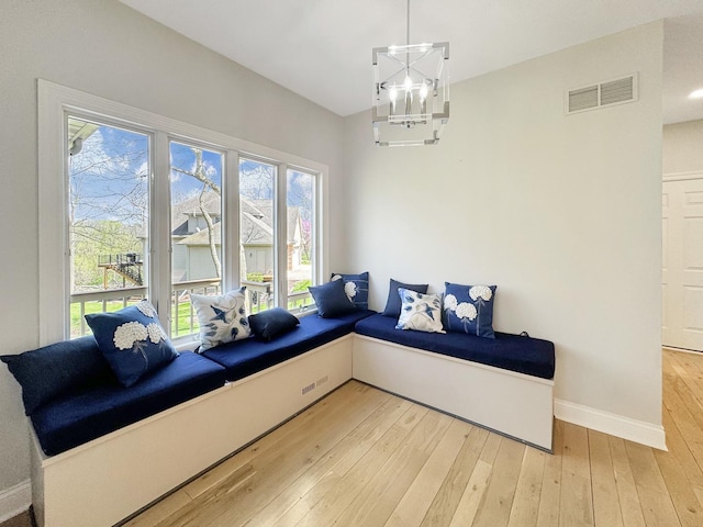 living room with hardwood / wood-style flooring and a notable chandelier