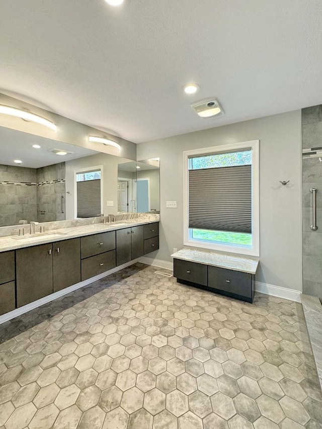 bathroom with vanity and a shower with door