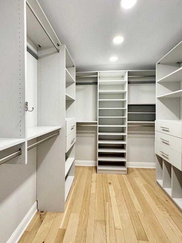 walk in closet with light wood-type flooring