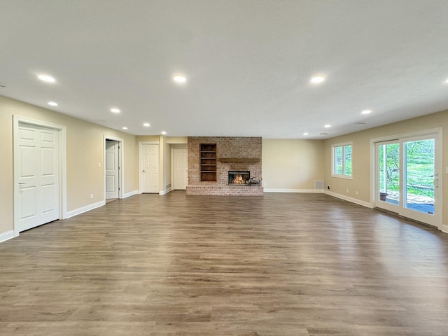 unfurnished living room featuring a fireplace and hardwood / wood-style floors