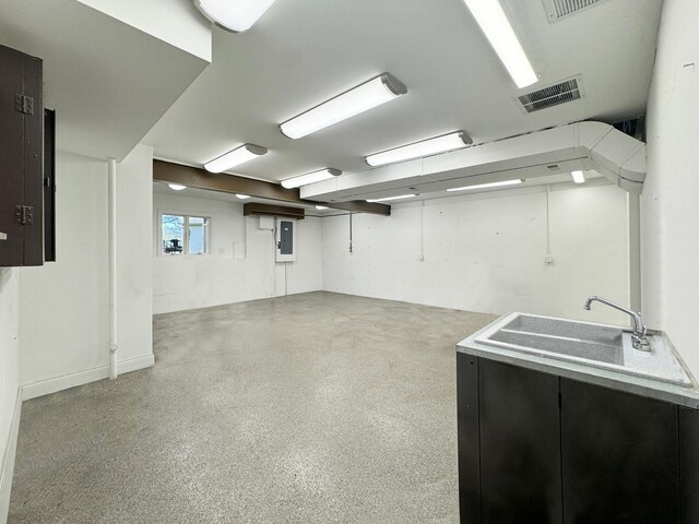 basement featuring sink and electric panel