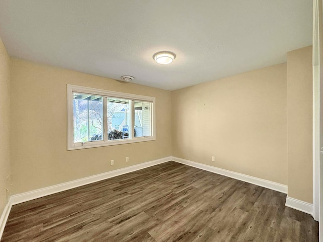 empty room featuring dark hardwood / wood-style flooring