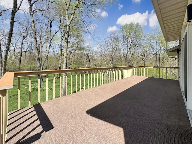 wooden deck featuring a lawn