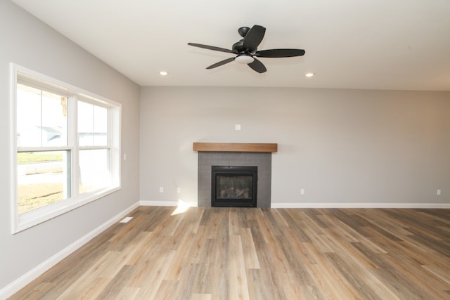 unfurnished living room featuring wood-type flooring and ceiling fan