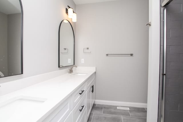 bathroom with dual bowl vanity and tile floors