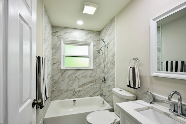 full bathroom featuring oversized vanity, toilet, and tiled shower / bath