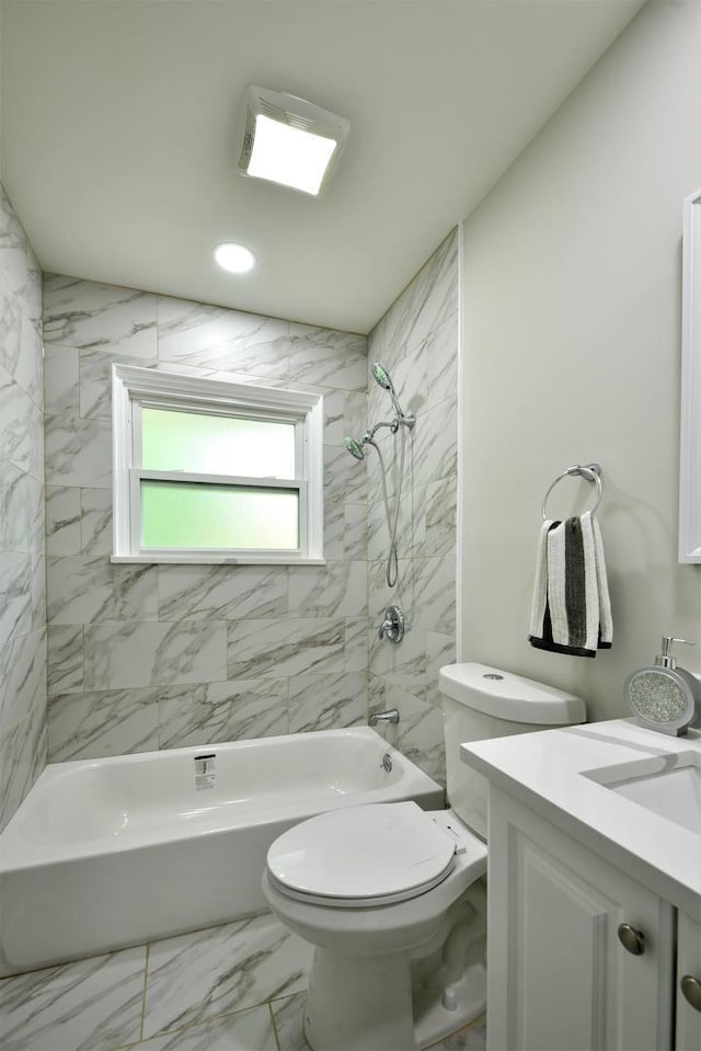 full bathroom featuring toilet, tile floors, vanity, and tiled shower / bath