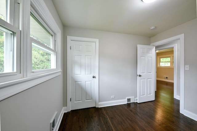 unfurnished bedroom featuring dark hardwood / wood-style flooring