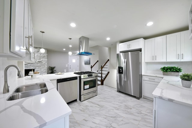 kitchen with hanging light fixtures, white cabinetry, appliances with stainless steel finishes, and sink