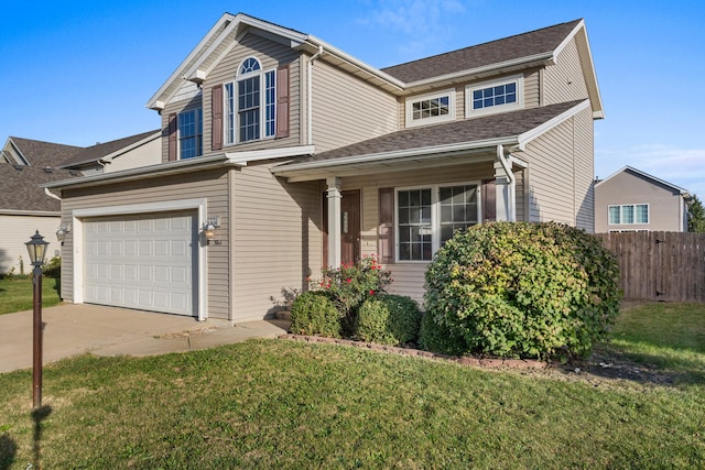 view of front of property featuring a front yard and a garage