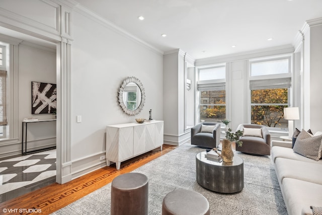 living room featuring wood-type flooring and crown molding