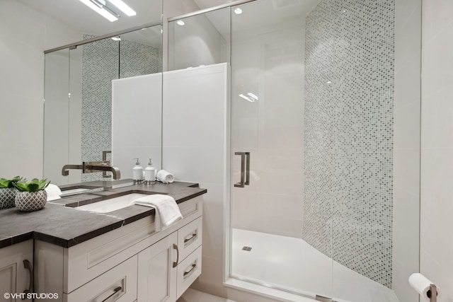 bathroom with an enclosed shower and large vanity