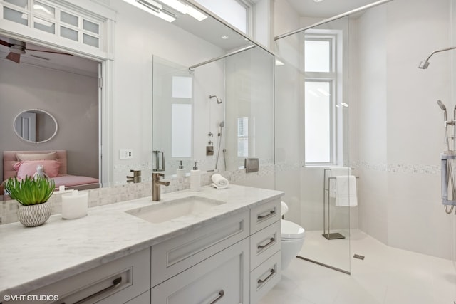 bathroom with ceiling fan, tile floors, an enclosed shower, vanity, and toilet