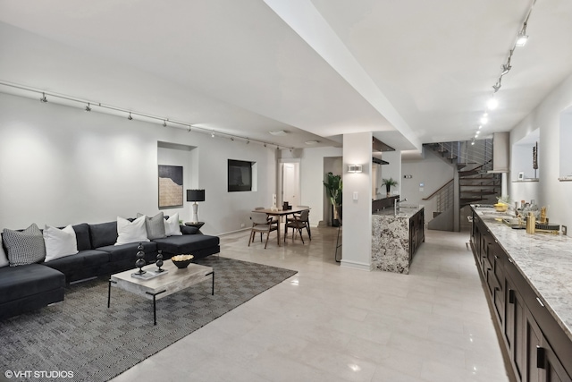 tiled living room featuring rail lighting