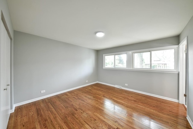 empty room with wood-type flooring