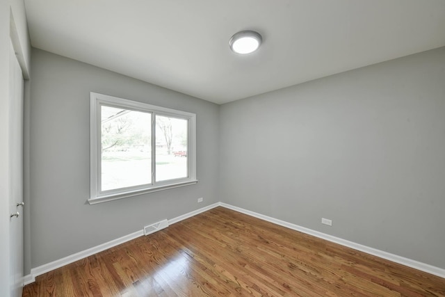 unfurnished room with light wood-type flooring