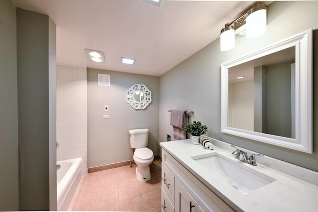 full bathroom with tiled shower / bath, toilet, large vanity, and tile flooring