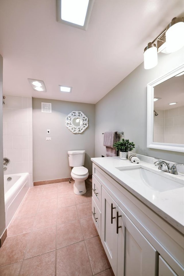 full bathroom featuring tiled shower / bath, tile flooring, toilet, and vanity