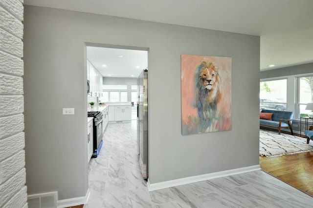 hallway with light hardwood / wood-style floors