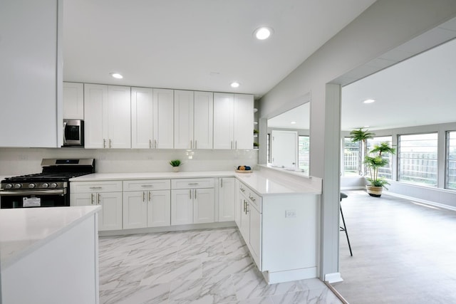 kitchen with a healthy amount of sunlight, appliances with stainless steel finishes, and white cabinetry