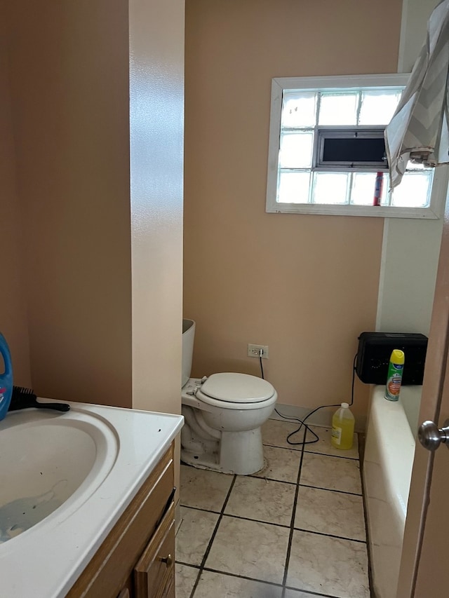 bathroom with toilet, tile floors, and vanity