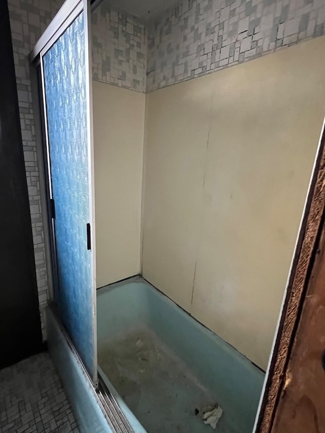 bathroom featuring tub / shower combination and tile flooring