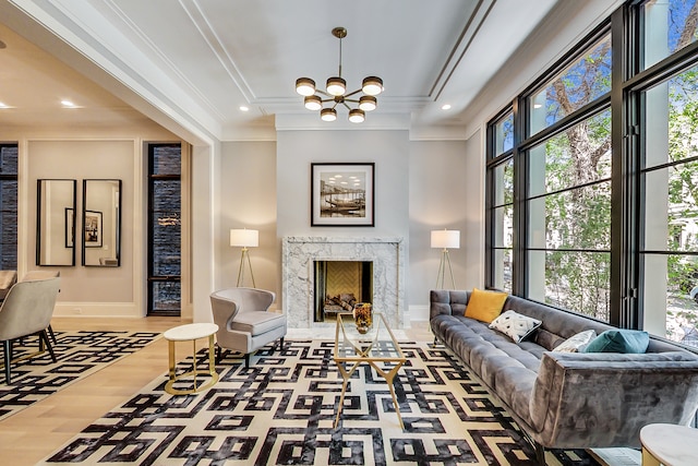 interior space featuring crown molding, a high end fireplace, a notable chandelier, and dark hardwood / wood-style flooring